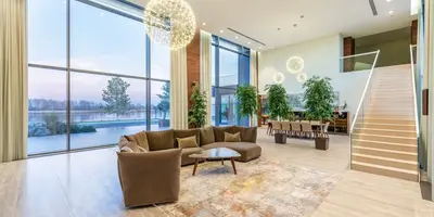 living room with seating area and stairs going up looking out over a lake