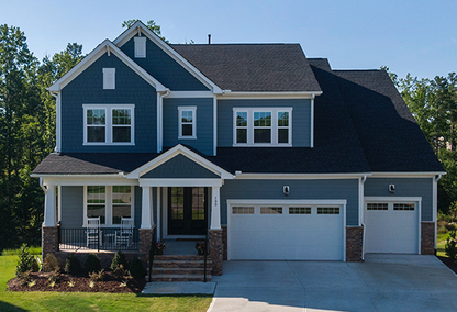 Blue and white home with large driveway