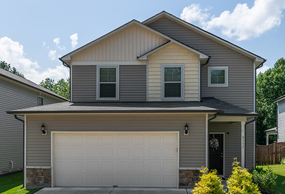 Tan and white 2 story home with white garage door