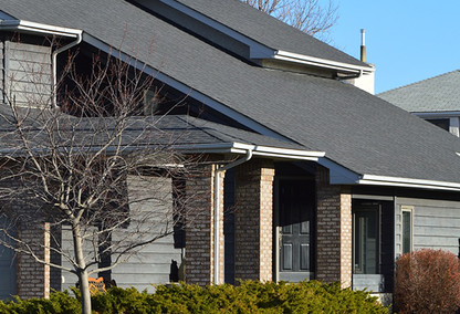 Gray home with brick columns