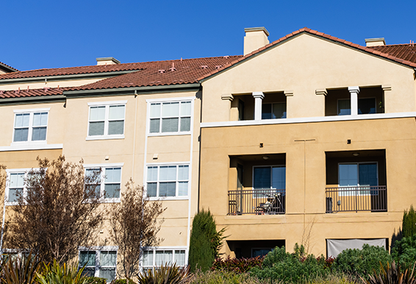 3 story building with red tile roof