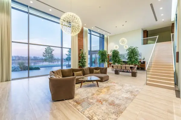 living room with seating area and stairs going up looking out over a lake
