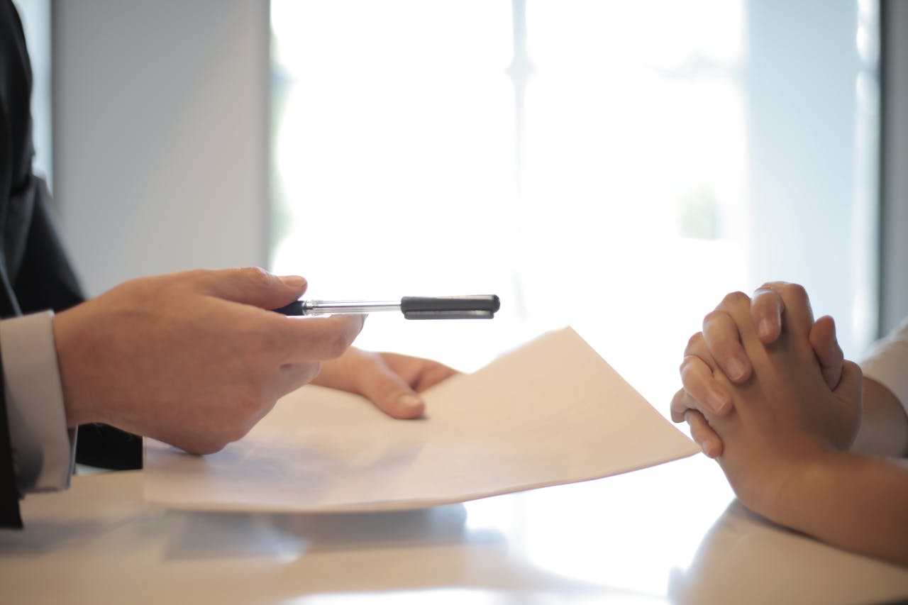 A man handing a paper to a woman