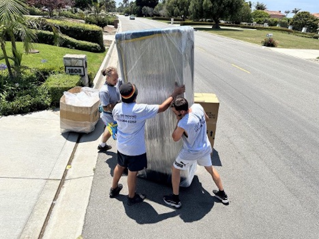 men moving a large box